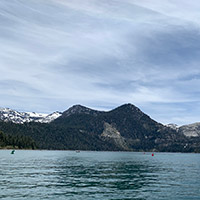 View from a boat of Lake Tahoe’s water and a mountain beyond
