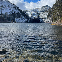 Rippling waters of Eagle Lake with snow covered mountains beyond