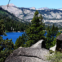 Echo Lake with a large rock in the foreground, and a mountain in the background 