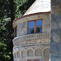 Upper window of Vikingsholm estate with trees in the background