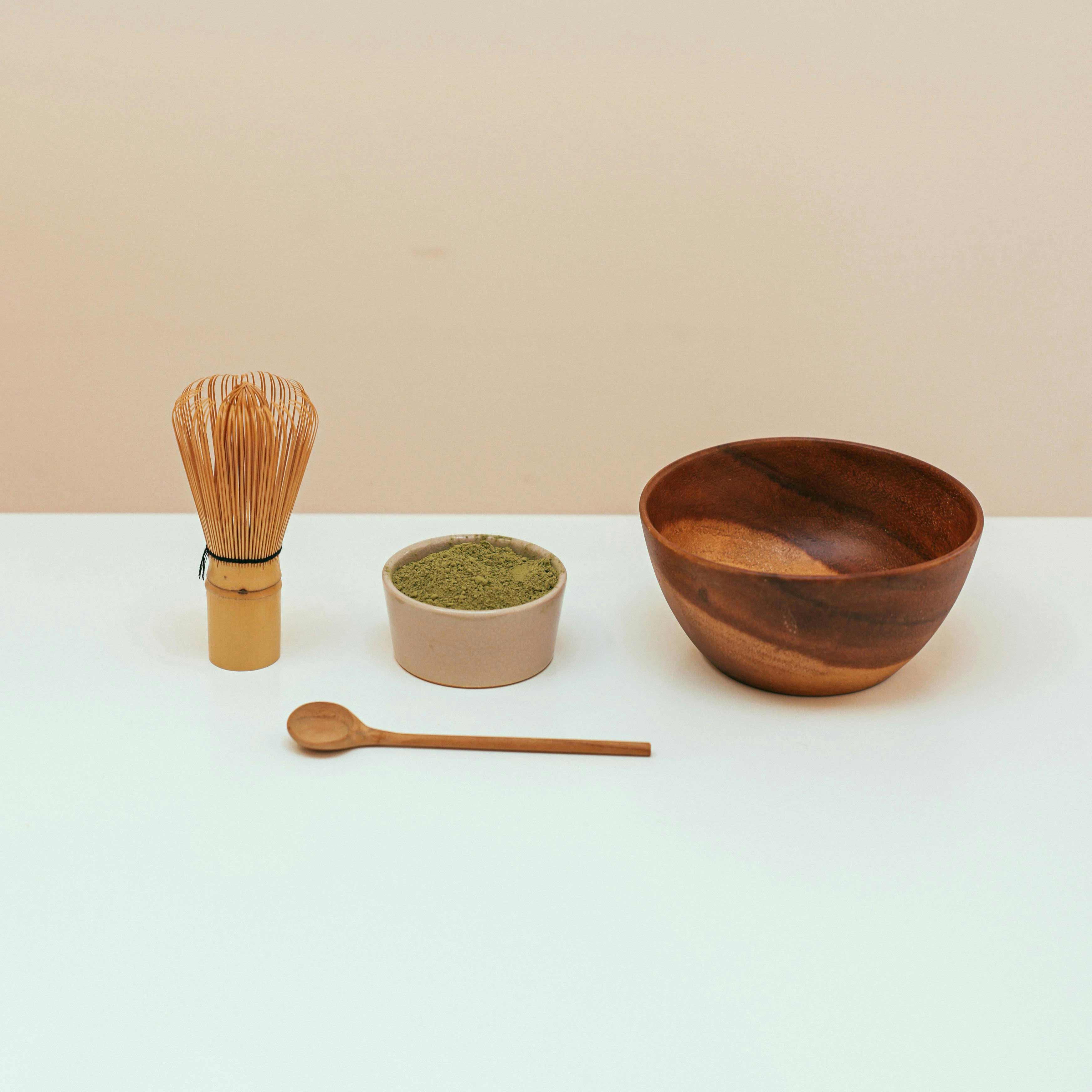 silver spoon with a brown powdered matcha called hojicha.