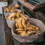 three baskets of yellow bananas