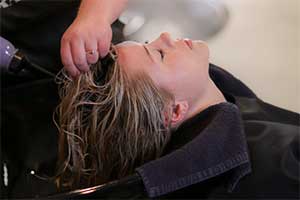 A woman having her hair washed at the salon.