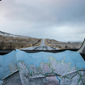 a roadmap resting on the dash of a vehicle looking forward