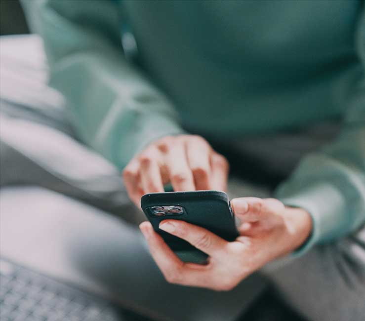 Hands are holding a phone.