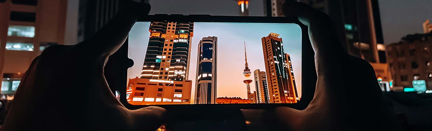 A picture of someone taking a picture of some buildings.