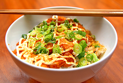 Japanese katsu over rice with green onions and spicy mayo