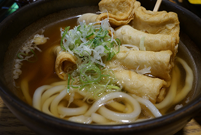 Udon noodle soup with fish cakes and tofu skin rolls