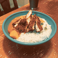 japanese curry served with chicken katsu in a blue bowl