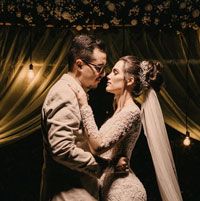 A newly married couple dances close in the evening