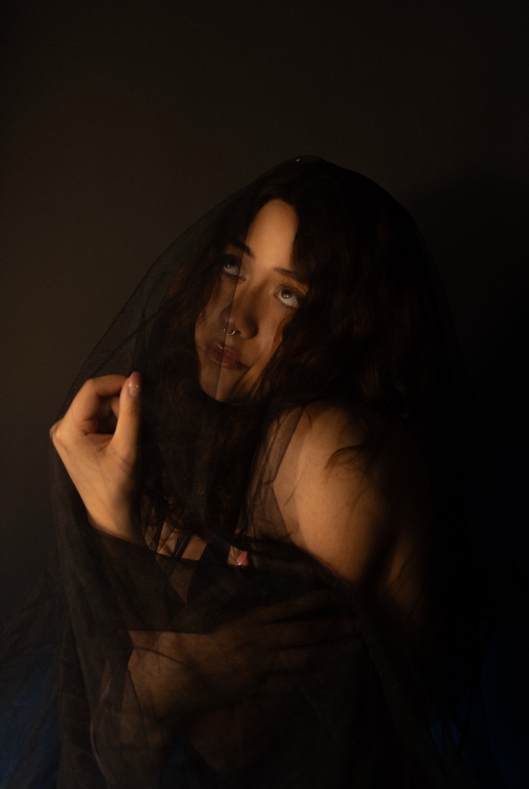 A studio portrait in soft, considered light.