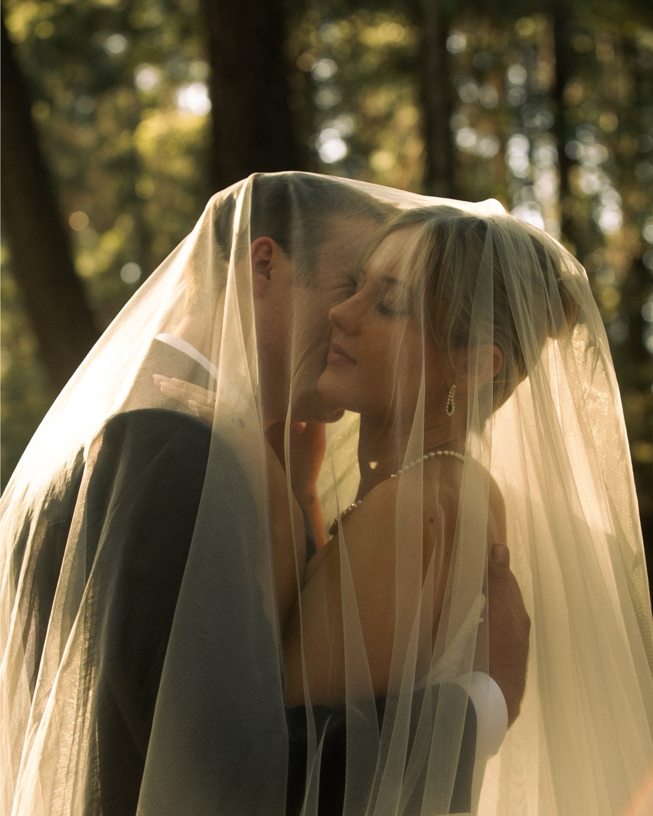 A bride and groom in a tender moment from their wedding day.