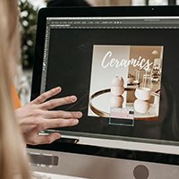 A graphic designer works on an advertisement for ceramics.
