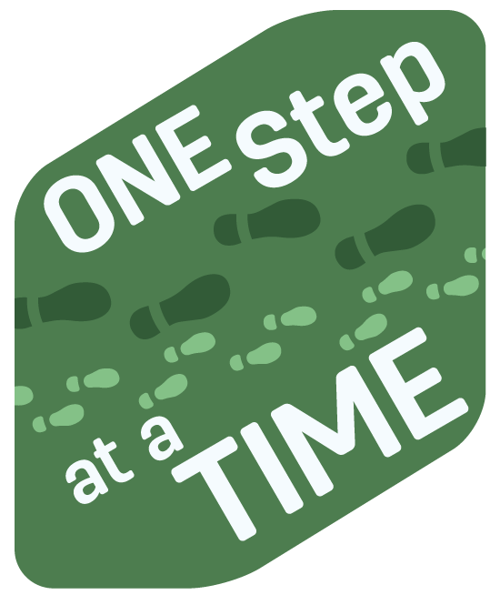A green sign with the words "One Step at a Time", between them foot prints of two different sizes and colors make a path from left to right.