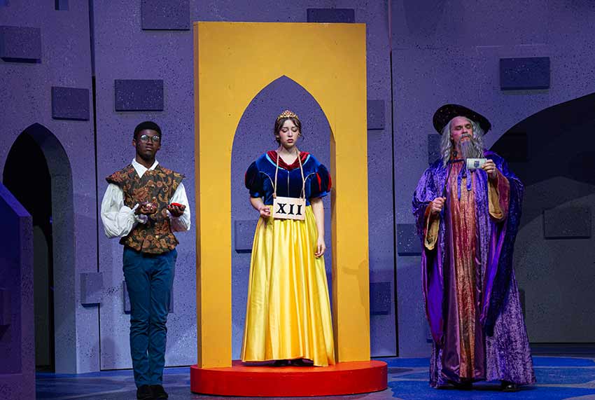 Photo of 3 people on stage including a princess in the middle