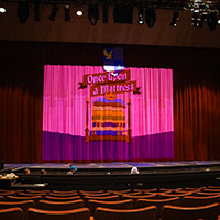 Click on this photo of a theater stage in red and pink colors and you will get transferred to the Events Photography page