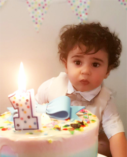 Rasah's one-year-old birthday photo while he was very surprised to see a lighted candle