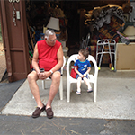 Image of older man sitting and talking with small child