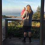 Image of man holding a child on a porch