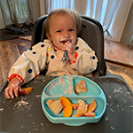 Image of baby making a mess eating food