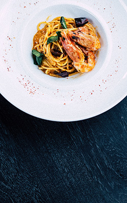 Pasta with prawns on dinner plate