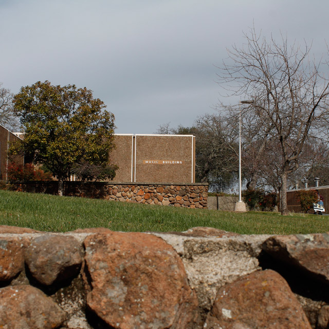 A far away building which says 'Music Building' on it.