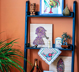 Orange wall with art pieces