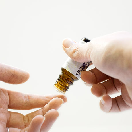 hands holding an essential oil bottle