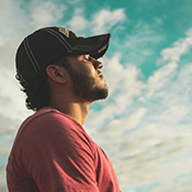 a man staring at the blue sky