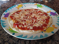 Torilla pizza with pasta sauce and mozzarella and parmesan cheese.