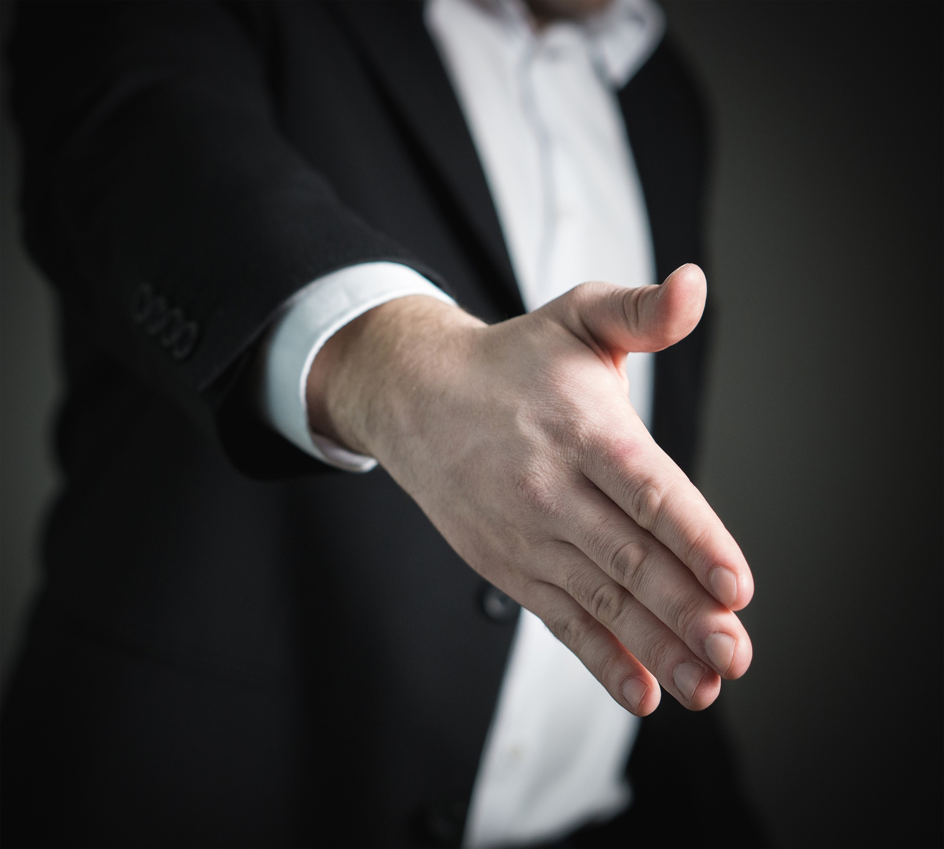 picture of a business man extending his hand